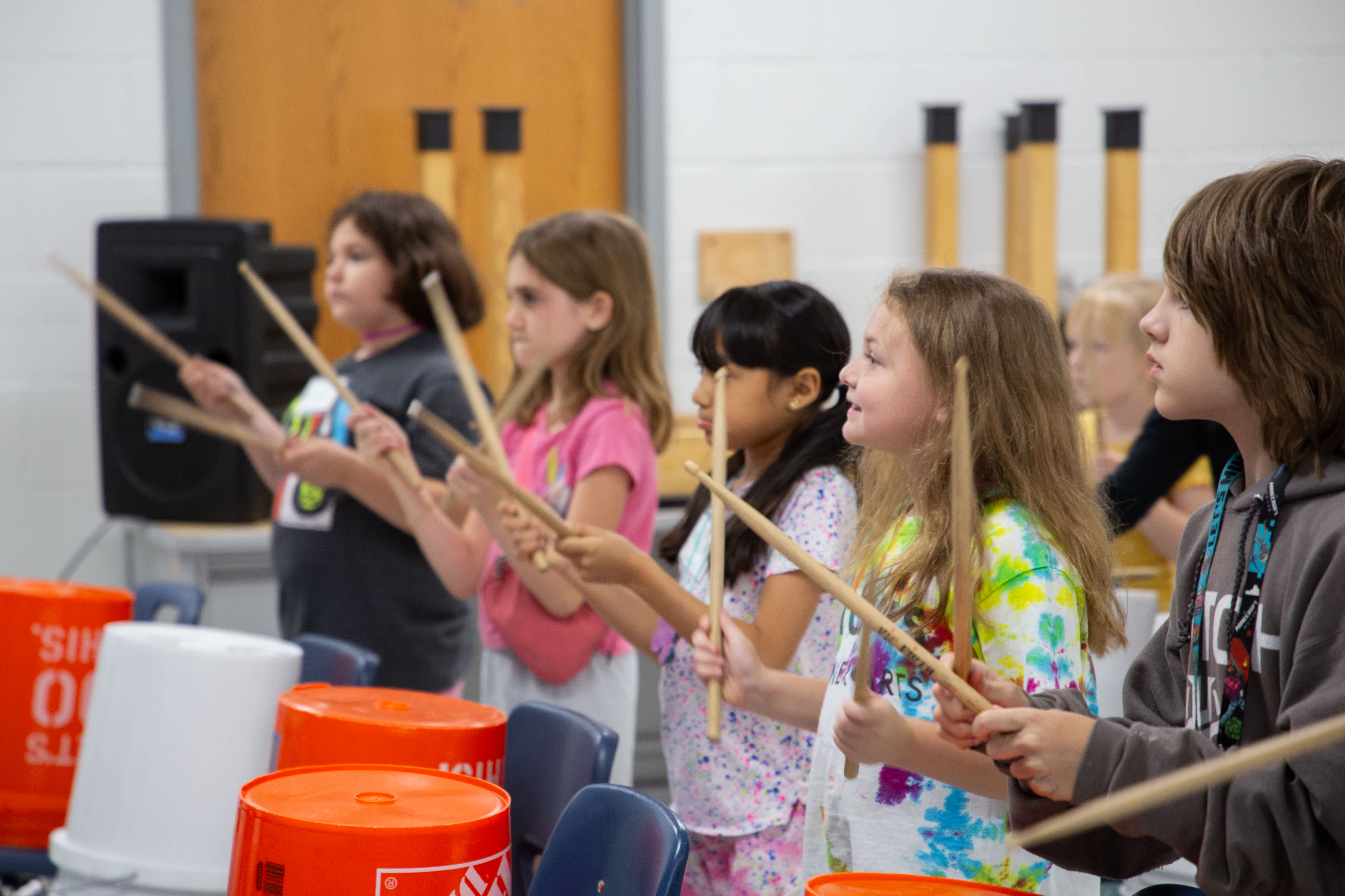 students play bucket drums
