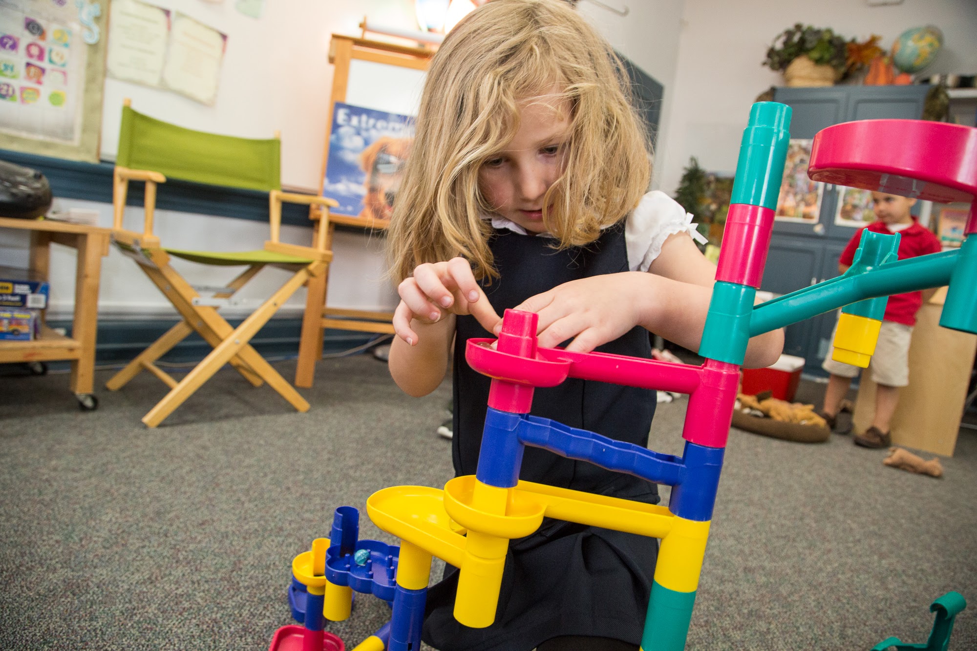 girl creating tower with plastic blocks