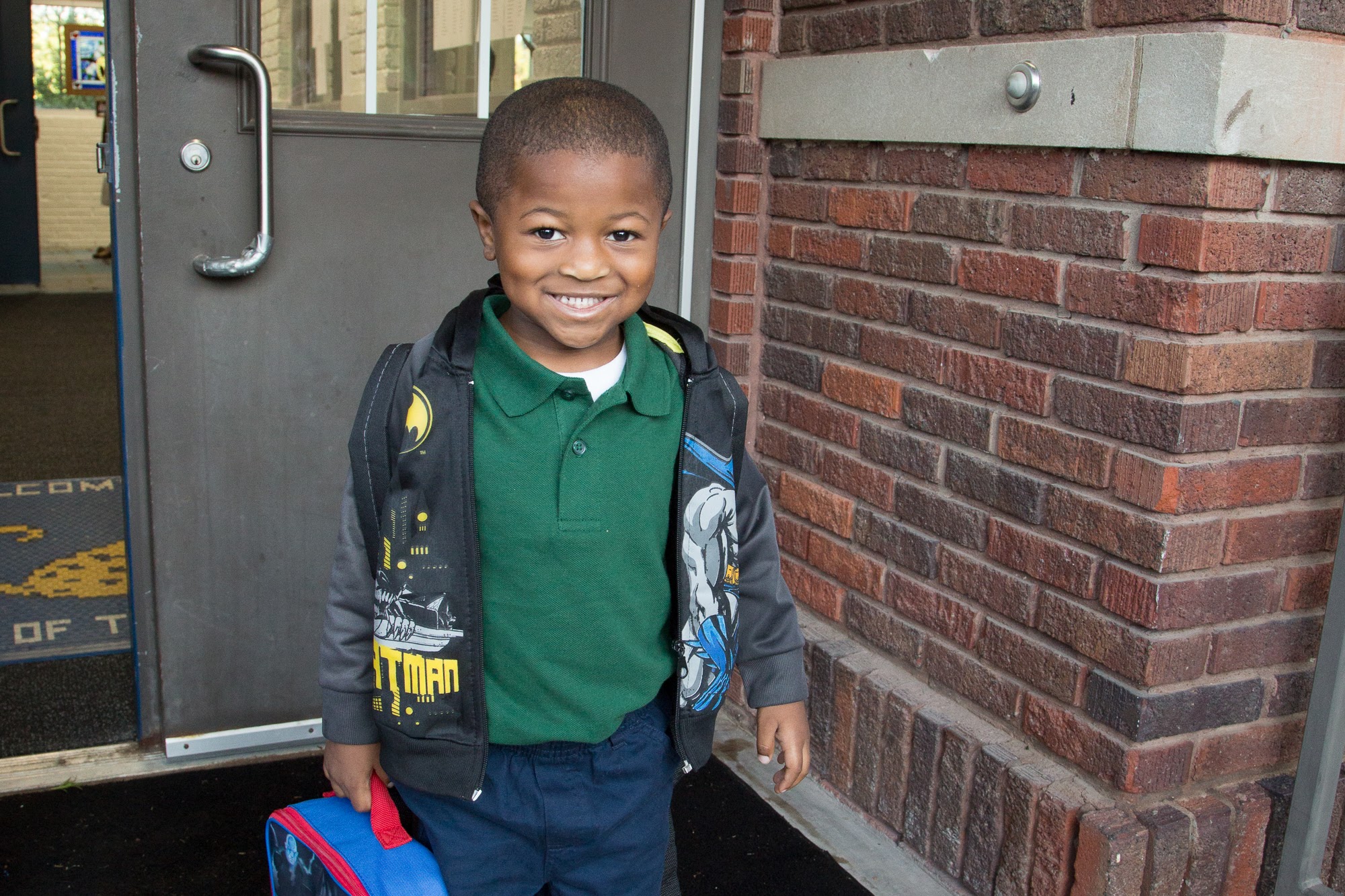 kindergarten boy wearing awesome batman jacket