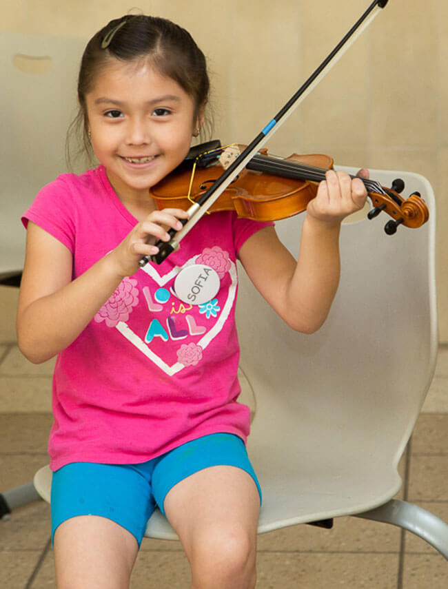 teacher hands out art supplies to student