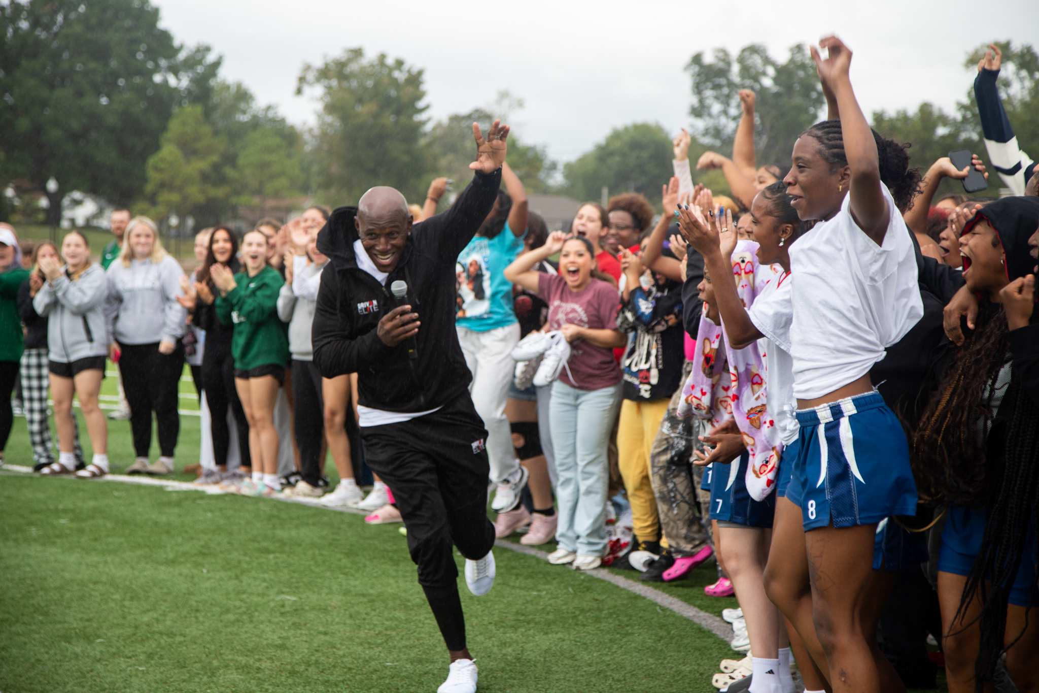 Donald Driver runs past cheering flag football players
